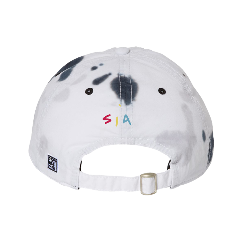 White baseball cap with colorful ’SIA’ text and black splotches.